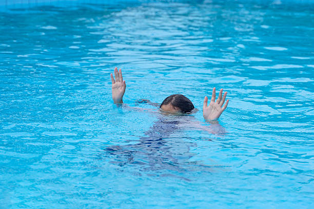 istock A girl drowned while swimming in a pool. She raised her hand to ask for help. 2211966672