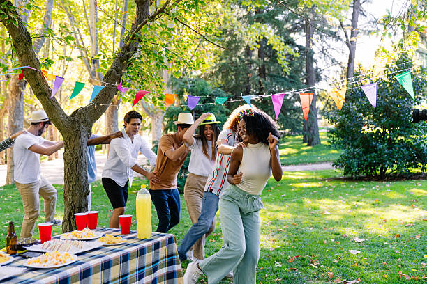 istock Cheerful multi-ethnic friends dancing conga line at a park party 2211968326