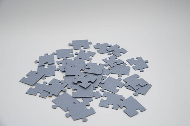 istock monochromatic puzzles in a pile lying on a white background 2211972015