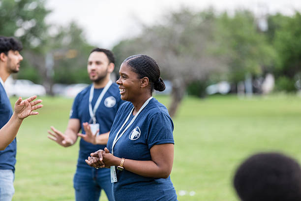 istock Happy Volunteers Talking Outdoors at Community Event 2211975771