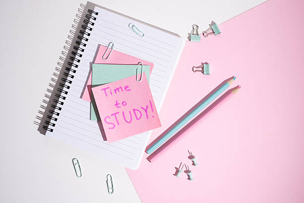 istock Time to study - written message in the workplace. Stationery, notebook, paper clips and sticky notes. Concept of learning 2211975789