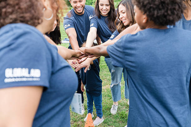 istock Diverse Group of Volunteers Stacking Hands in Teamwork 2211975808