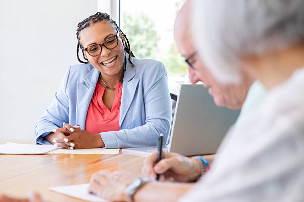 istock Professionals Sign Papers at Closing Table 2211976418