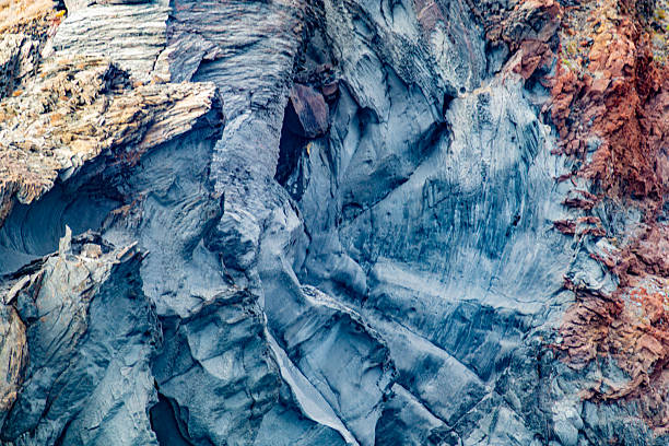 istock Slope of rock formation with rough patterns on surface of rock wall 2211979842