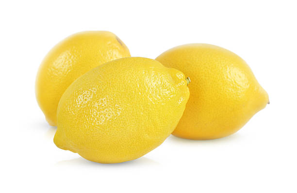 three whole lemons are isolated on a white background