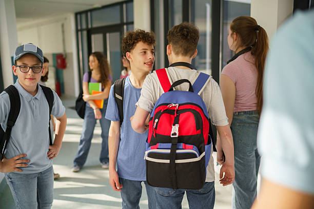 istock Group of children talking in school corridor 2211982237