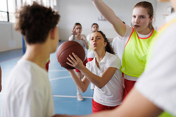 istock Girl playing basketball whit her team 2211982739