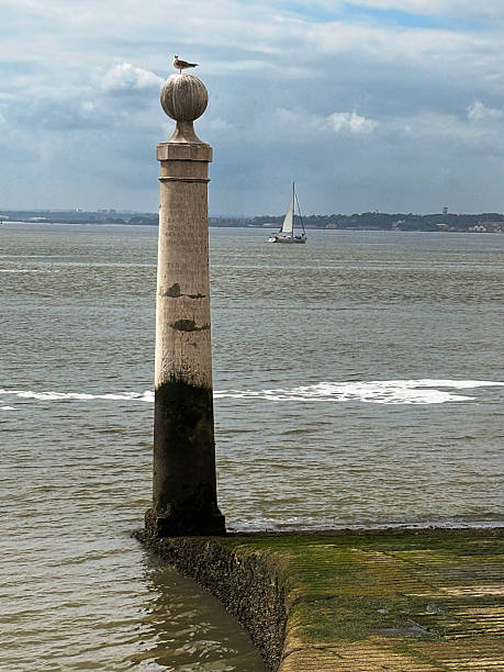 one of the two 18th century marble columns, the Cais das  Colunas, marking an old pier in the Tagus River waterfront in the Praca do Comercio area of historic downtown Lisbon, now regarded as a symbolic welcome to visitors