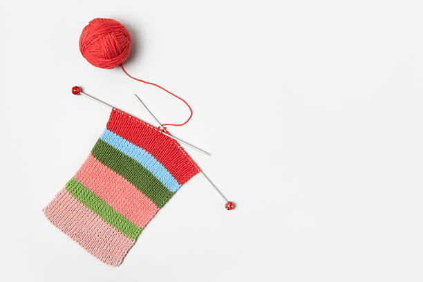 istock Ball of thread with knitting needles and knitted fabric 2211983033