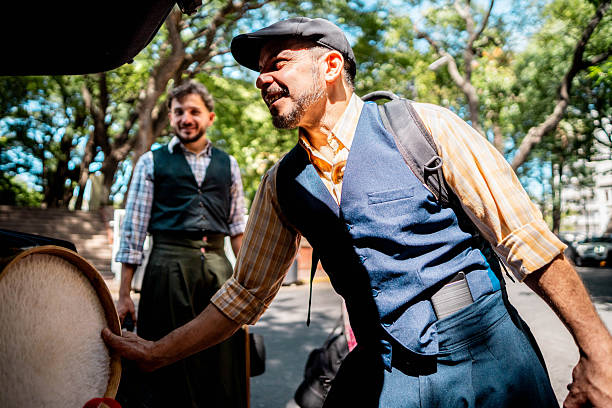 Performance argentinian man storing drum in car trunk