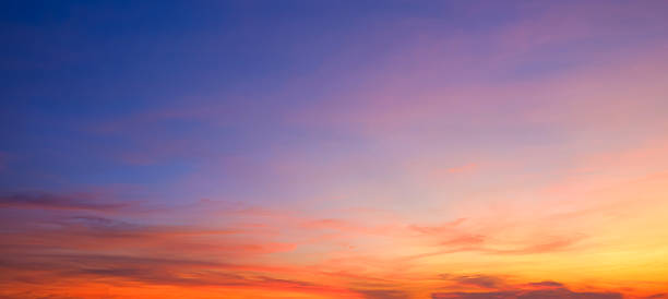 istock Evening sky background after sundown with dramatic dusk clouds and colorful orange yellow natural light on blue panoramic twilight sky 2211983657