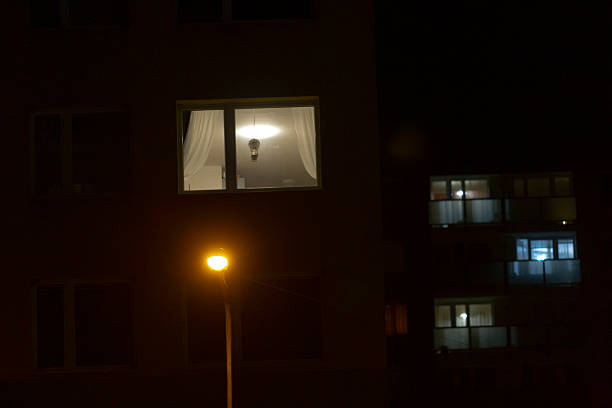 istock A calming nighttime apartment window with a lamp and draped curtain 2211984443