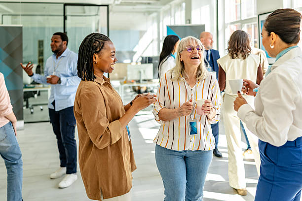 istock Discussion on financial services among diverse professionals in a modern bank setting during a networking event 2211986865