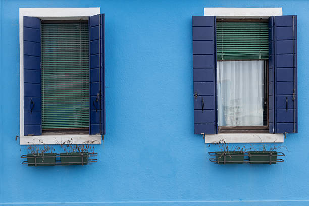istock Blue facade with shuttered windows in Burano 2211987629