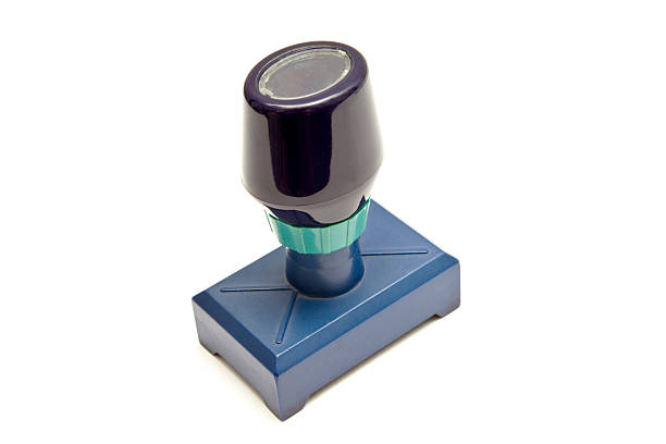 Rubber stamp, featuring a dark-colored top and a blue base on a white background.