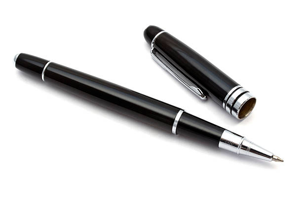 istock Black pen is captured with its cap off against a stark white backdrop. 2211988216