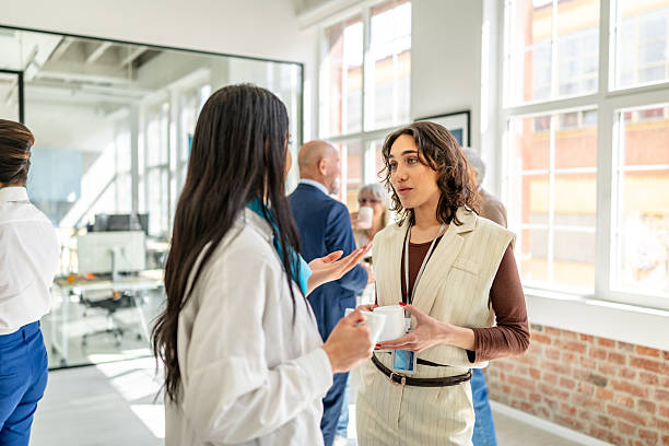 istock Financial advisors discuss client agreements in a modern bank office with a diverse group of professionals present 2211990156