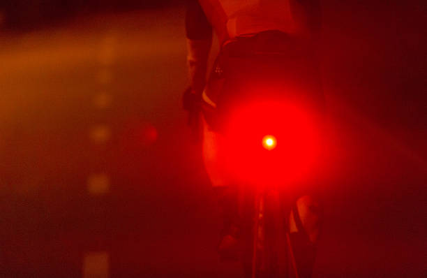 istock A Cyclist Riding at Night with a Bright Reflective Red Light for Safety 2211991147