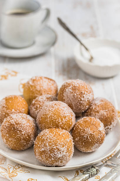 istock Fried curd balls with sugar on a white plate 2211999899