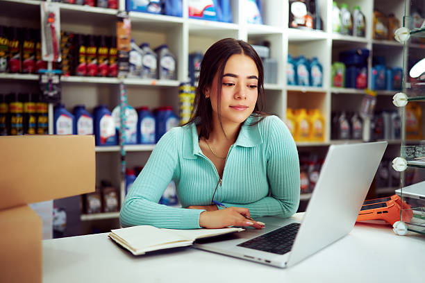 istock Young shop assistant managing online orders in a retail store 2212000121