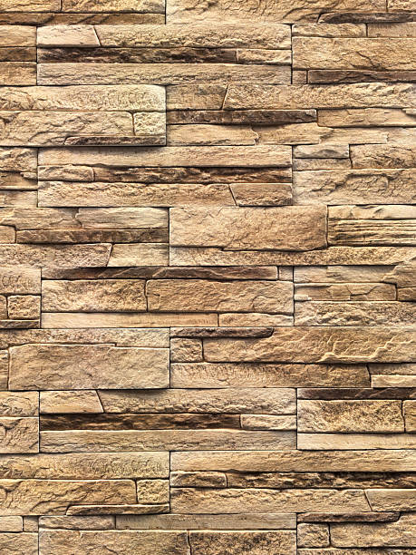 istock Textured wall design with layered stones in brown shades 2212001248