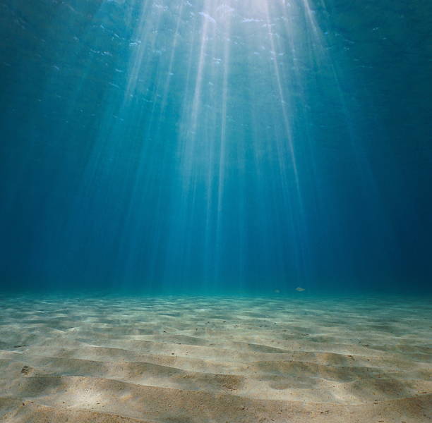 istock Rays of sunlight underwater with sandy seabed Mediterranean sea 2212002796