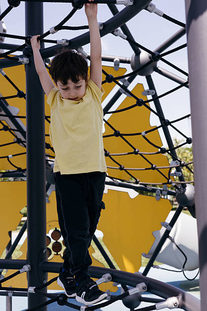 istock Little boy climbing on the playground 2212004353