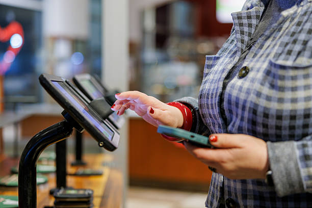 istock Digital payment at retail terminal. Shopper completes transaction with smartphone and touchscreen. 2212006253