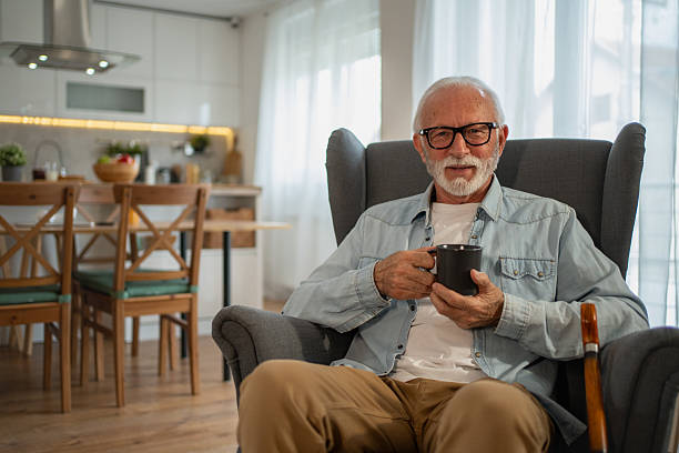 istock Senior man relaxing at home drinking a cup of coffee or tea 2212012873