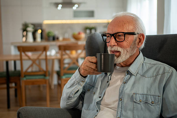 istock Senior man relaxing at home drinking coffee 2212012885