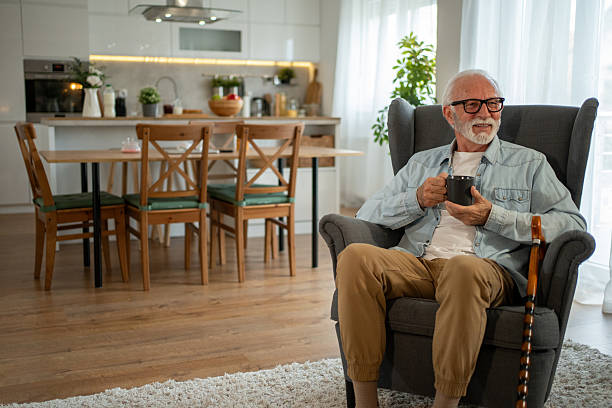 istock Senior man relaxing at home drinking tea 2212012901