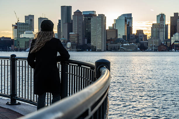 istock A woman looking at Boston skyline during a sunset. 2212015570