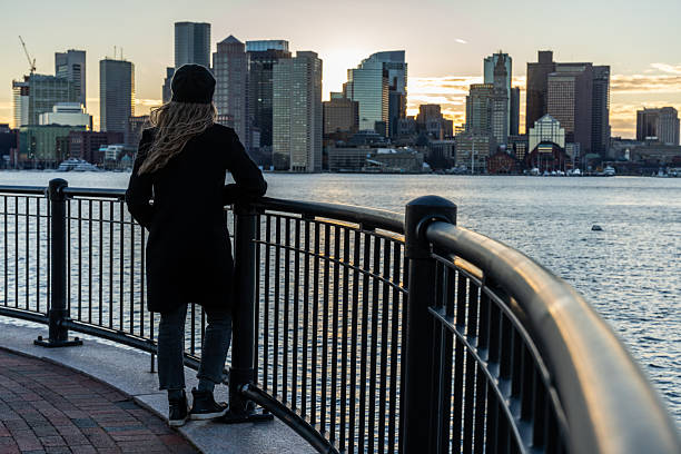 istock A woman looking at Boston skyline during a sunset. 2212015573