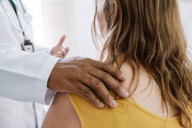 istock Doctor comforting patient with a hand on the shoulder 2212017014