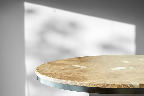 istock Round marble table top with tree leaves shadow drop on white wall background for mockup product display 2212019148