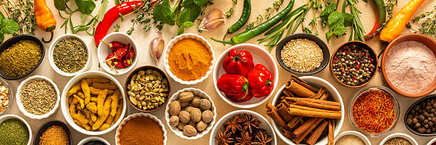 istock Collection of assorted spices and herbs spread on a beige background, blending exotic aromas and colors to inspire flavorful cooking, banner 2212025714