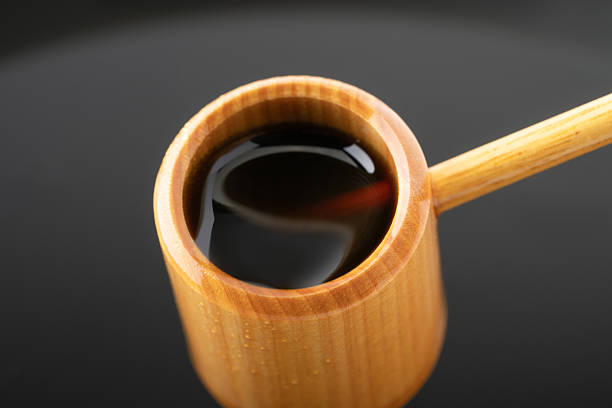 Black vinegar scooped with a ladle