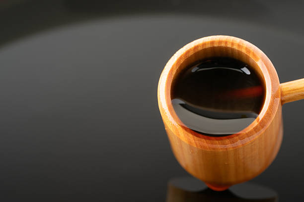 Black vinegar scooped with a ladle