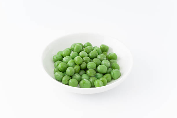 istock Green peas in a dish 2212027107