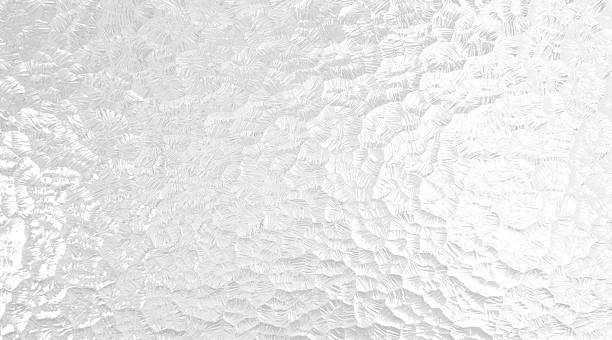 Shiny textured silver white metallic hammer tone embossed aluminum foil surface abstract background.  Aluminium foil (or aluminum foil in American English; occasionally called tin foil) is aluminium prepared in thin metal leaves. The foil is pliable and can be readily bent or wrapped around objects. Thin foils are fragile and are sometimes laminated with other materials such as plastics or paper to make them stronger and more useful. In the United Kingdom and United States it is often informally called tin foil, just as steel cans are often still called tin cans. Metallised films are sometimes mistaken for aluminium foil, but are actually polymer films coated with a thin layer of aluminium. Approximately 75% of aluminium foil is used for packaging of foods, cosmetics, and chemical products, and 25% is used for industrial applications (e.g., thermal insulation, electrical cables, and electronics). A metal leaf, also called composition leaf or schlagmetal, is a thin foil used for gilding and other forms of decoration. Metal leaves can come in many different shades, due to the composition of the metal within the metal leaf. Metal leaves are usually made of gold (including many alloys), silver, copper, aluminium, brass (sometimes called Dutch metal typically 85% Copper and 15% zinc) or palladium, as well as platinum. Frosted glass is produced by the sandblasting or acid etching of clear sheet glass. This creates a pitted surface on one side of the glass pane and has the effect of rendering the glass translucent by scattering the light which passes through, thus blurring images while still transmitting light. It has 10–20% opacity.