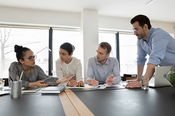 istock Multiethnic startup team gathering in office, discussing project 2212029264