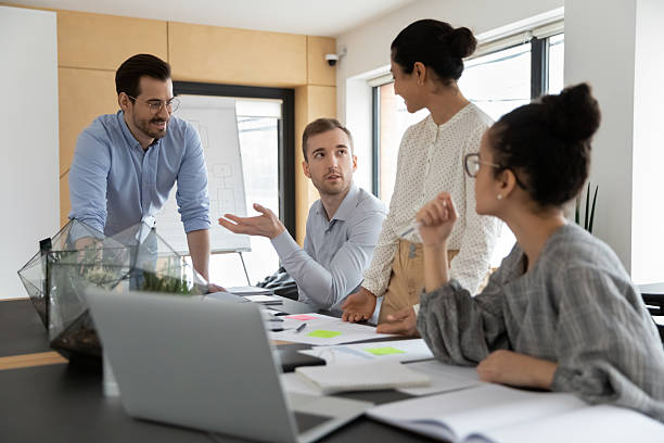 istock Diverse business team discussing project at corporate briefing 2212029732