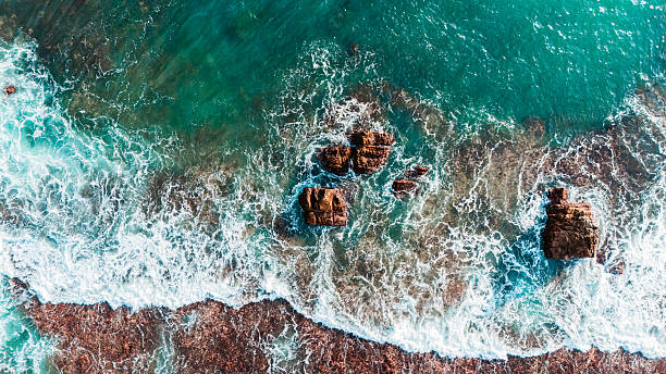 istock Stunning ocean wave clash on rocks. summer beach and travel backdrop themed content. 2212029907