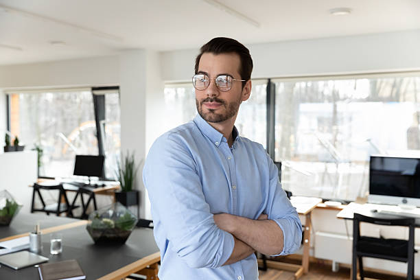 istock Pensive business man wearing glasses, posing with hands folded 2212029977