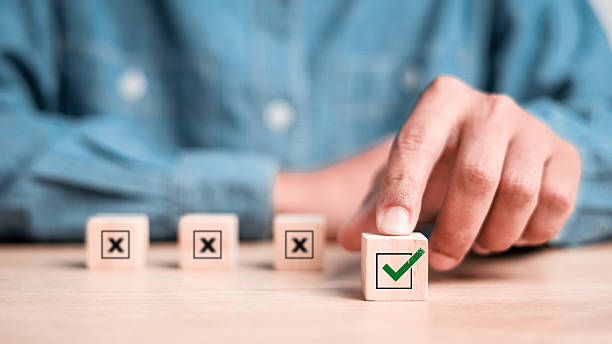 istock Businessman select blue correct sign mark between Red Cross mark which print screen on wooden for approve and reject business project proposal concept. 2212032034