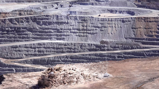 istock Panoramic view of the blasting process in an open pit mine 2212036223