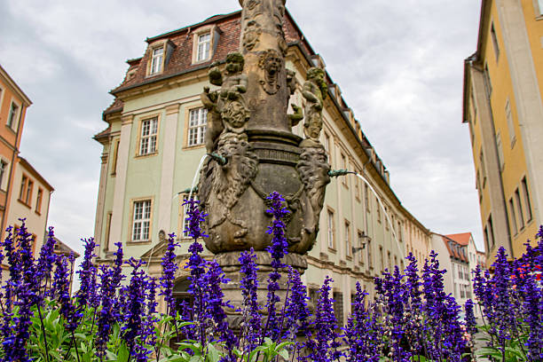 istock Buildings with medieval architecture next to many flowers 2212036242