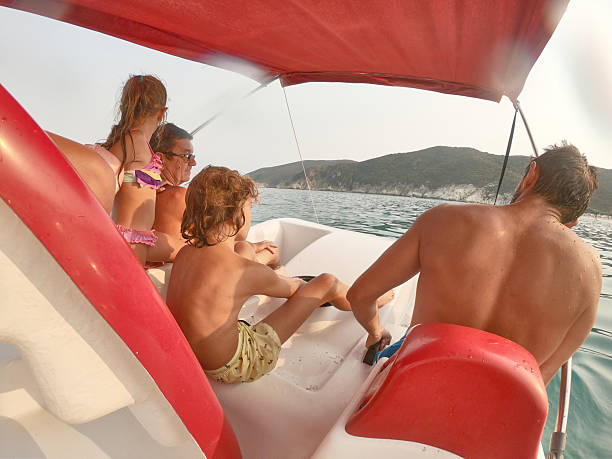 Extended family on paddleboat enjoying summer.