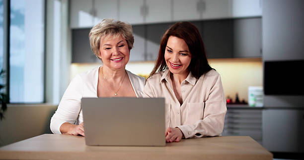istock Teaching Tablet To Senior Woman 2212041241