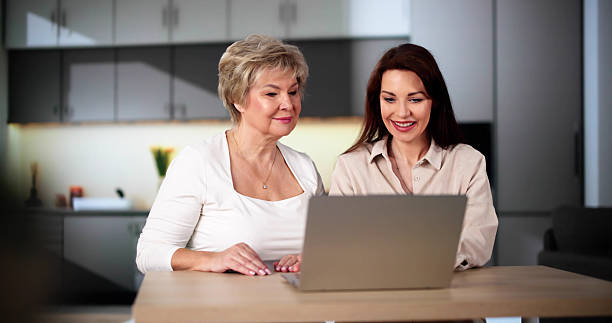 istock Teaching Tablet To Senior Woman 2212041253